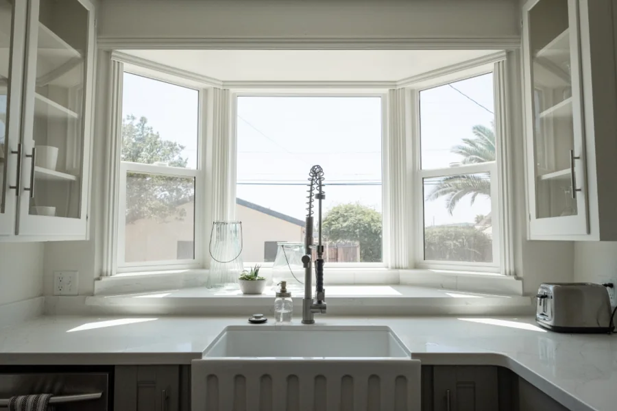 A bright, clean kitchen with a window over the sink